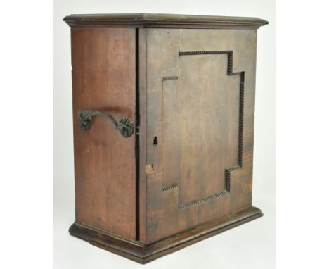 An early 20th century mahogany watchmakers specimen chest cabinet. The cabinet having a chamfered flared top over a panelled 