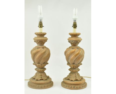 A pair of Classical inspired resin wooden effect desk table lamps. Each lamp having a reeded turned body over a splayed foot 