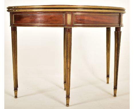 A French Biedermeier 19th century mahogany and brass bound games / card table or roulette table. The table of demi-lune form 