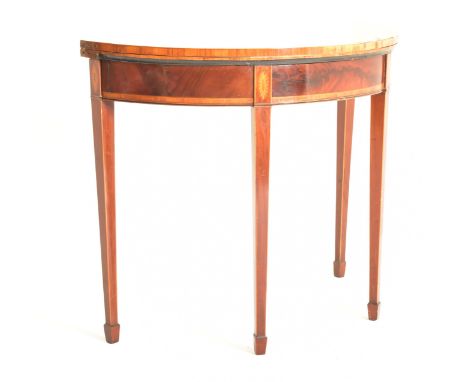 A George III&nbsp;late 18th century mahogany crossbanded demi-lune hall card game table. The half moon table raised on square