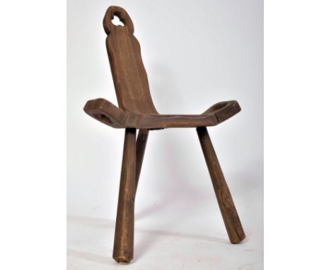 A late 19th century Brutalist elm wood birthing milking tripod stool / chair. The stool having&nbsp;a hand carved seat and ba