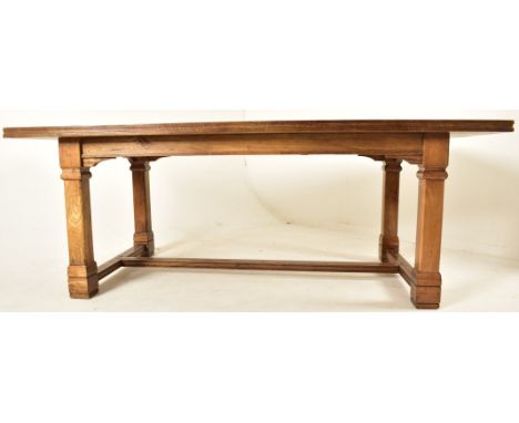 A large continental hardwood and walnut veneered refectory farmhouse dining table. The table having a rectangular top with mo