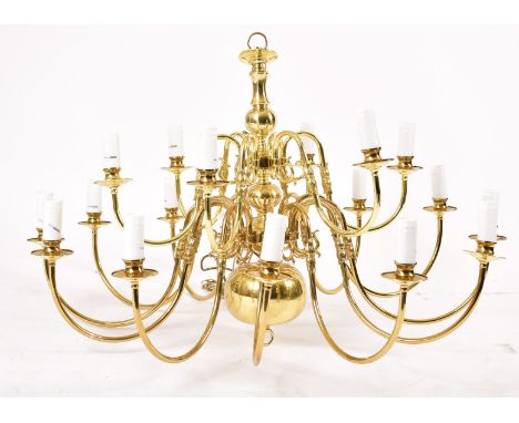 A large 21st century brassed chrome metal and acrylic two tier twelve arms chandelier ceiling light. The chandelier having tw