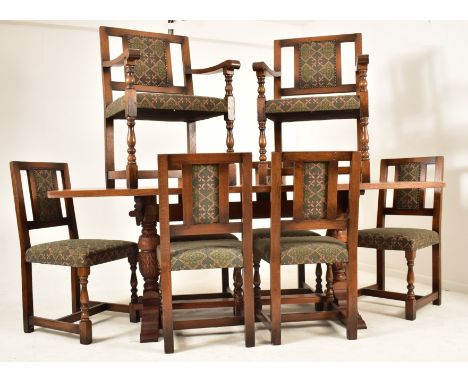 A large 20th century solid oak refectory dining table and matching eight chairs. The table of rectangular form raised on carv