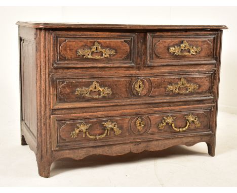 A French 19th century oak commode / chest of drawers. The chest having a shaped top with chamfered edges over two over two dr