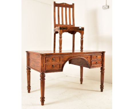 A French inspired walnut writing desk table with chair. The desk having a shaped top with panels detailing. Central arched kn