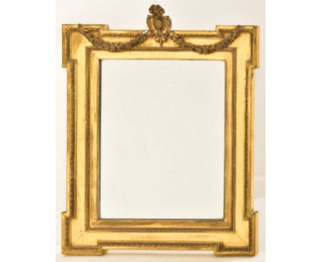 A 19th century Adams revival gilt wood and gesso worked wall hanging mirror. Harebell swag with armorial cartouche panel atop