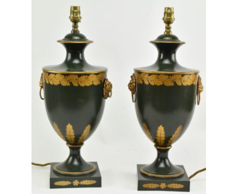 A pair of Regency style toleware painted metal desk table lamps in the shape of handled urns. Each lamp having a flared rim o