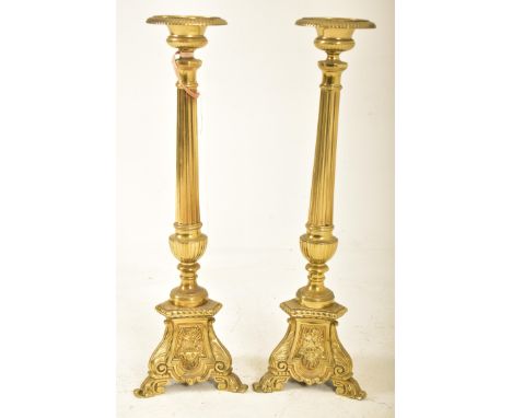 A pair of 19th century Victorian brass floor standing prickets, likely ecclesiastical in nature. Each pricket featuring class