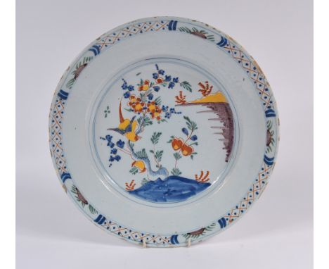 An English Delftware polychrome charger 18th Century decorated in the Chinese taste with phoenix and blossom, 35cm