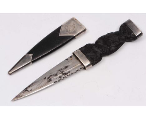 A Scottish silver mounted dirk with geometric carved handle and leather sheath (crested) by T K Ebbett of Edinburgh, Edinburg