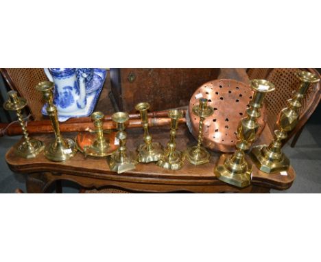 A Victorian brass chamber stick and eight various 18th/19th Century brass candlesticks