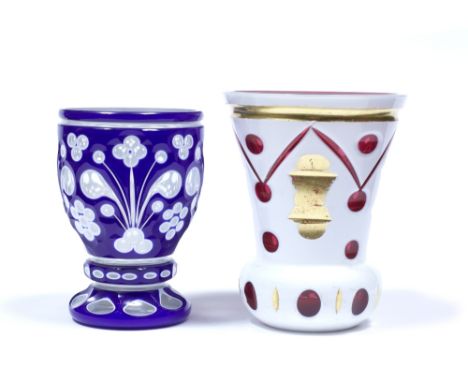 A Bohemian clear glass goblet with blue overlay Mid 19th century foliate design, height 12 cm, and a ruby glass small vase wi