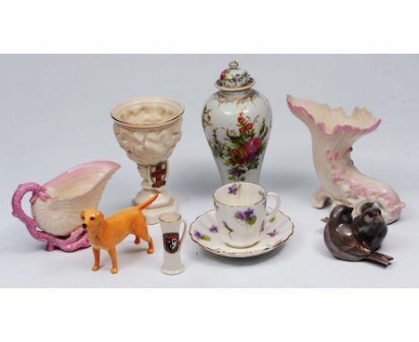 A Goss model of The Melrose Cup a Belleek shell jug, a Belleek cornucopia, a Royal Copenhagen model of birds, a Beswick hound