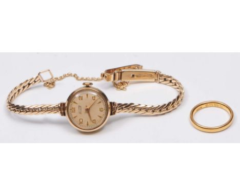 A 22ct gold wedding band of plain form 3.4 grams, together with a ladies Tissot 9ct gold wrist watch with integral strap