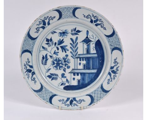 An English Delftware blue and white charger with Chinese designs, 33cm