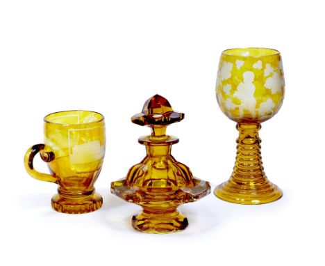 A collection of Bohemian amber glass 19th century  to include a scent bottle, cup, and goblet, each with floral and architect