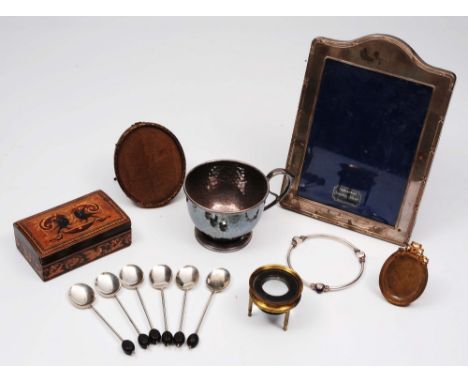 A silver frame and a silver bangle, various silver coffee spoons and three other pieces