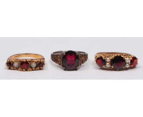 A 15ct gold ring with triple garnet and seed pearl setting, together with a further 9ct gold ring in a similar style and a si