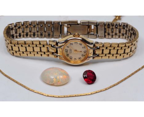 A loose garnet together with a loose opal of oval form, a ladies Tissot wrist watch and a gilt chain