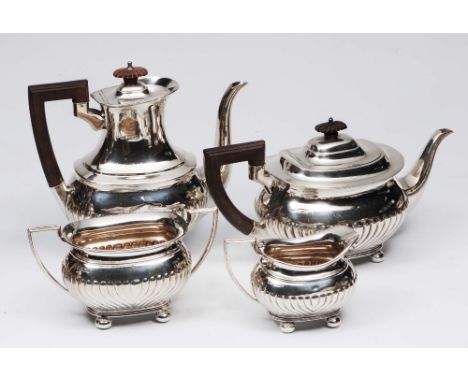 A silver four piece tea and coffee service of half fluted baluster form with shaped handles and spouts and bun supports, make