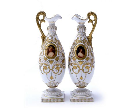 A pair of French white ground porcelain ewers late 19th Century possibly Haviland & Co, each  having an oval painted portrait