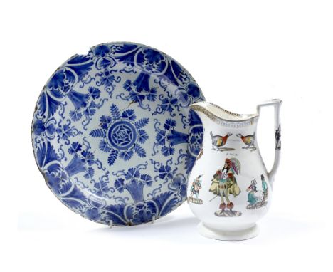 A Dutch Delftware charger 18th Century with foliate and carnation decoration, 34cm and a pottery jester jug 23.5cm (2)