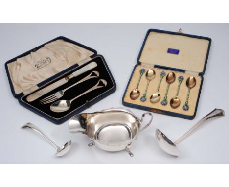 A silver three piece Christening set in original box, a cased set of six silver gilt coffee spoons with blue and green floral