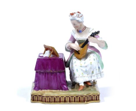 A Vienna figure 'Hearing' dated 1852 after the model by Schönheit, the lady playing a small guitar, seated by a table, her co