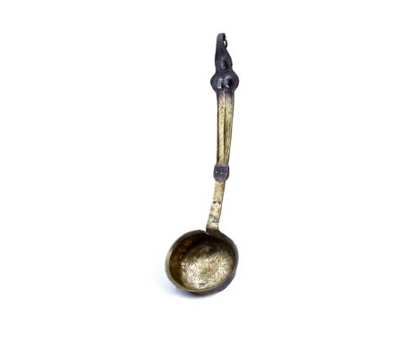 A brass continental ladle 19th Century with beaten handle