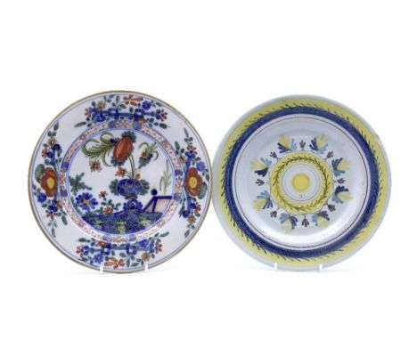 A Delftware polychrome dish 18th Century with provincial French flower designs, 23cm and one other faience polychrome circula
