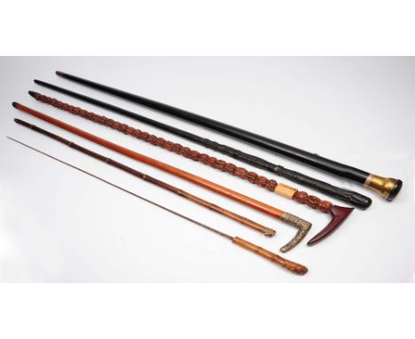 An ebony brass and inlaid walking cane circa 1900 with inset snuff mull to the top, a Japanese sword stick, 19th Century, an 
