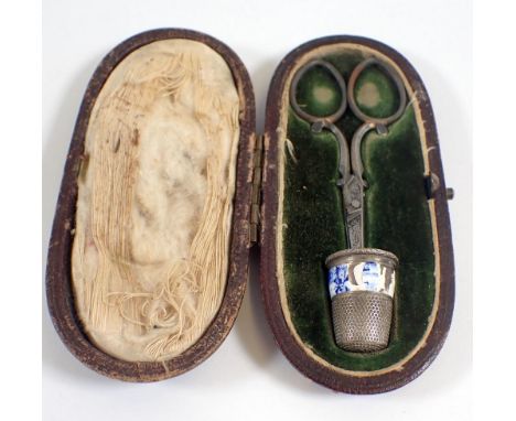 A 19th century cased pair of needlework scissors and a 900 standard silver and enamel thimble 