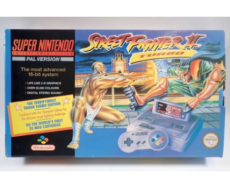 A Super Nintendo Entertainment system (SNES) console containing Street Fighter II Turbo complete with power supply, two contr