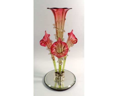 A Victorian cranberry and green glass epergne with central trumpet and three outer trumpets, on a later mirrored base, 44cm t