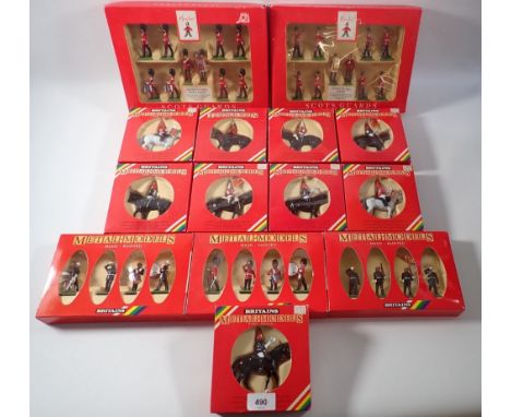 A box of fourteen Britains metal models including Scots Guard Band and Piper Band for Hamleys plus 7203 Royal Marine drum and