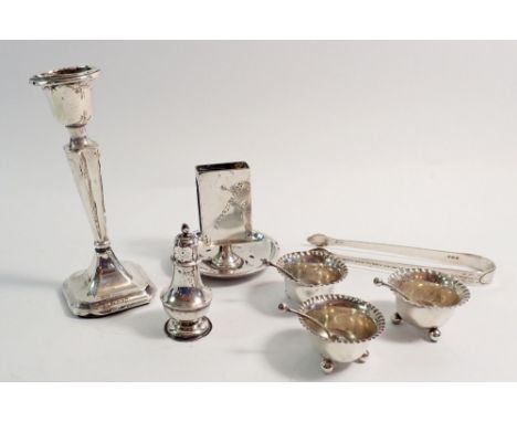 Three silver salts, a silver pepper pot, sugar tongs and a match holder ashtray, total weight 201g plus a silver candlestick 