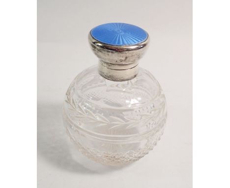 A cut glass scent bottle with blue enamel hinged lid, with inner stoppper, 11cm tall 