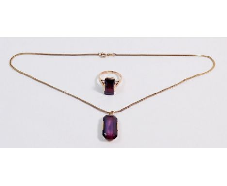A yellow metal and amethyst pendant (tested as gold) on 9 carat gold chain (chain 2.7g) plus a yellow metal ring set red ston