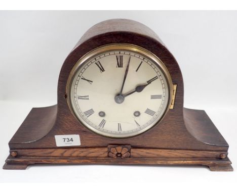An oak eight day striking mantel clock English made with silvered dial 