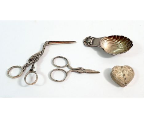 A collection of four Italian silver items including caddy spoon, heart-shaped box, ribbon threaders in the form of a stork an