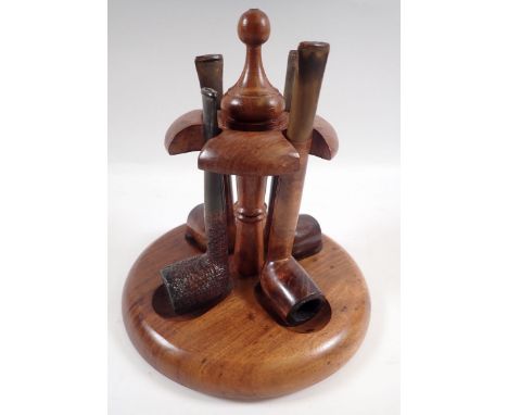 A pipe stand and four pipes 