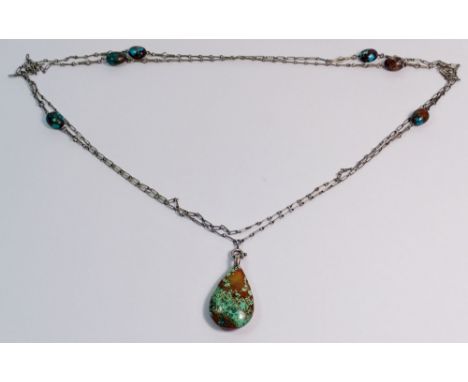 An Arts &amp; Crafts white metal turquoise matrix long pendant necklace with tear form drop and six interspersed beads to the