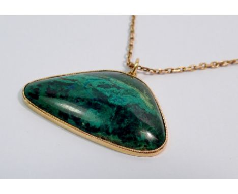 A yellow metal and malachite pendant (tested as gold) on yellow metal chain (unmarked and untested) 