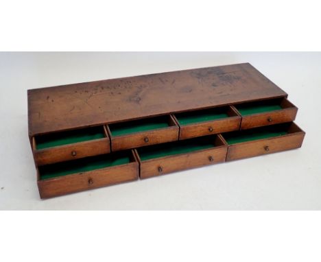 An oak table top collectors chest of seven drawers with brass button handles, 87cm wide 