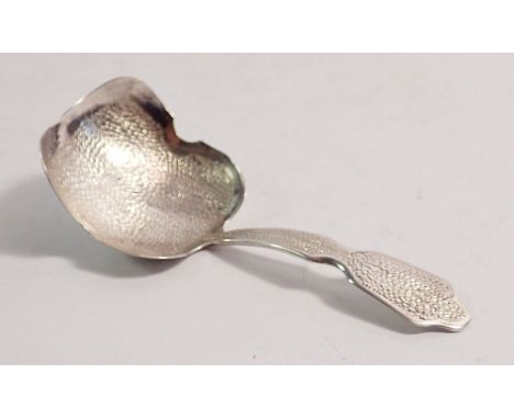 A silver caddy spoon, York 1828 by Barber, Cattle &amp; North with all over stippled decoration 