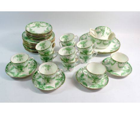 An Edwardian green printed tea service comprising twelve cups and saucers, twelve tea plates, milk and sugar 