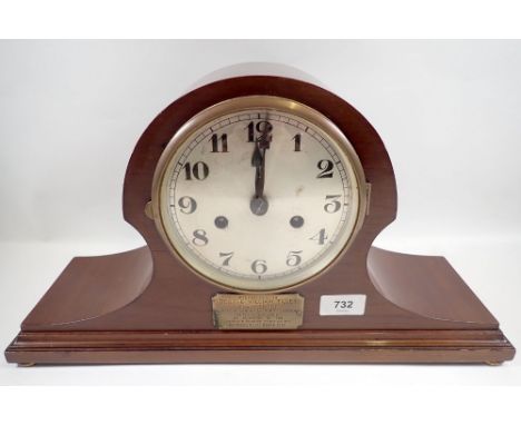A 1920's mahogany eight day striking mantel clock with presentation plaque, key and pendulum, 45cm wide 