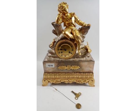 A fine 19th century French mantel clock with ormolu seated boy on silvered rocky base, with key and pendulum, 38cm tall 
