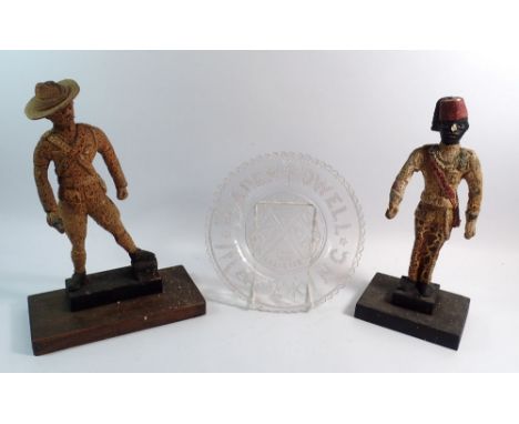 Two unusual Boer War figures (fire damaged) plus a pressed glass Lord Baden Powell plate 